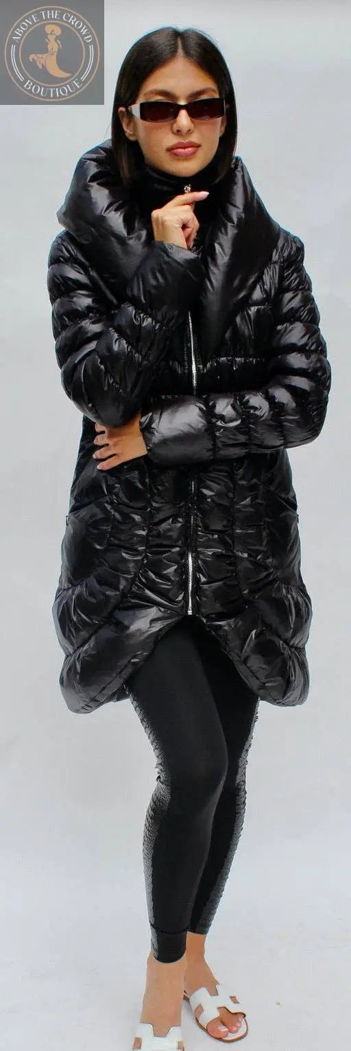 Woman wearing a black puffer coat and sunglasses on a white background